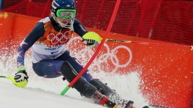 Eighteen-year-old is the youngest person ever to win gold in slalom; Canada beats U.S. in hockey semis.