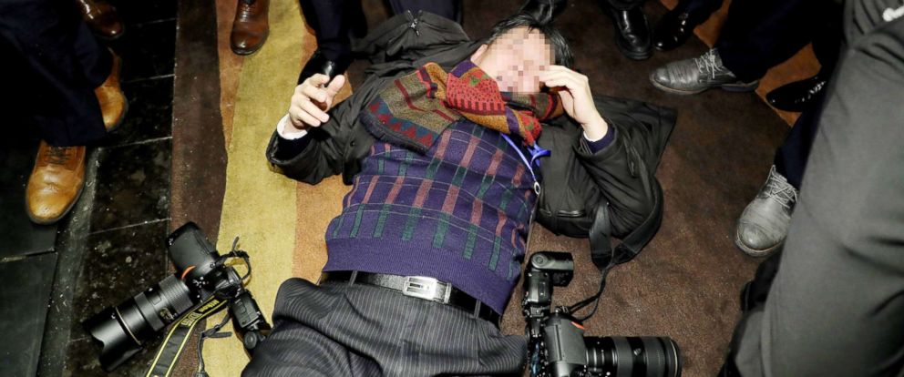PHOTO: A South Korean photojournalist lies on the ground after allegedly being beaten by Chinese security guards while covering an event in Beijing on Dec. 14, 2017.