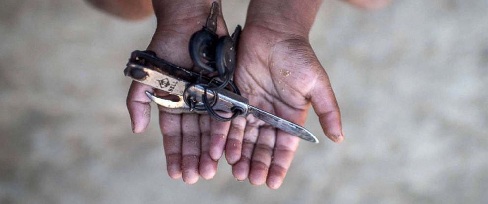 PHOTO: Rohingya migrant boy Warish Shah (3), who arrived in Bangladesh in September after his village was attacked, holds a pen knife with nail clippers that he plays with at the Thankhali refugee camp in Coxs Bazar, Dec. 2, 2017. 
