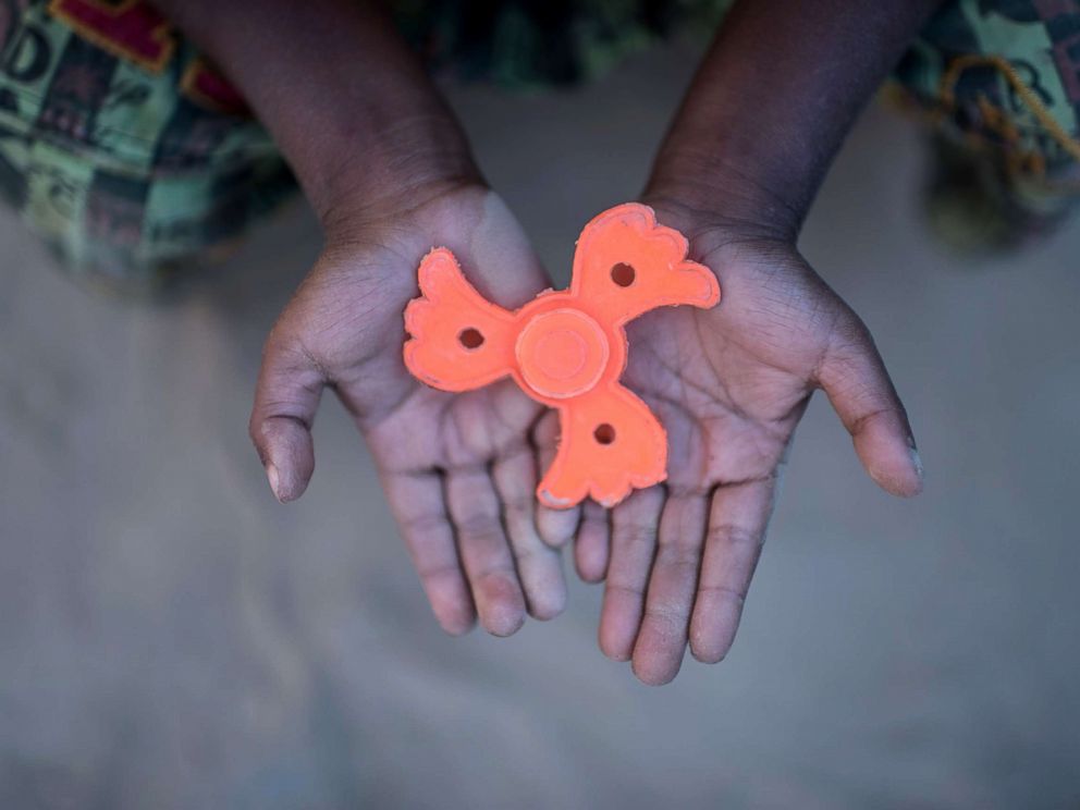 PHOTO: Rohingya migrant boy Mohammad Sadek (5) holds a plastic fidget spinner that he found discarded, at Thankhali refugee camp in Coxs Bazar, Dec. 2, 2017.
