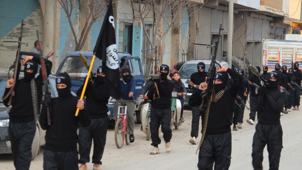 PHOTO: Fighters of al-Qaeda linked Islamic State of Iraq and the Levant carry their weapons during a parade at the Syrian town of Tel Abyad, near the border with Turkey, Jan. 2, 2014. 