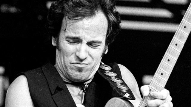 PHOTO: U.S. rock star Bruce Springsteen plays the guitar during a packed concert at a stadium in East Berlins Weissensee district, July 19, 1988.