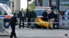 Police officers carry equipment while investigating a crime scene of an apparent attack that left one man confirmed dead and two people wounded near Woolwich barracks in London, May 22, 2013.
