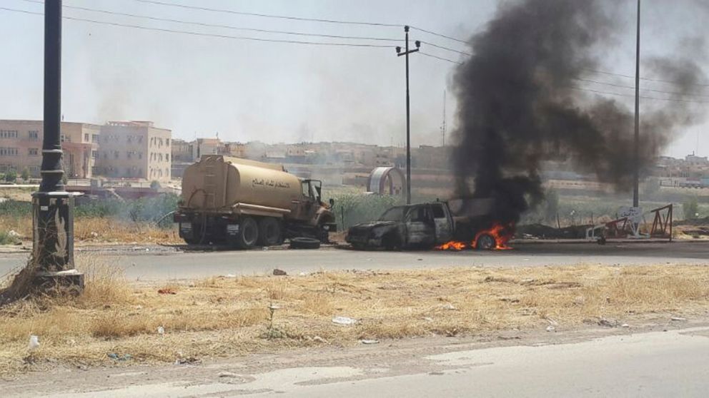 PHOTO: Burning vehicles belonging to Iraqi security forces are seen during clashes between Iraqi security forces and al Qaeda-linked Islamic State in Iraq and the Levant (ISIL) in the northern Iraq city of Mosul, June 10, 2014.