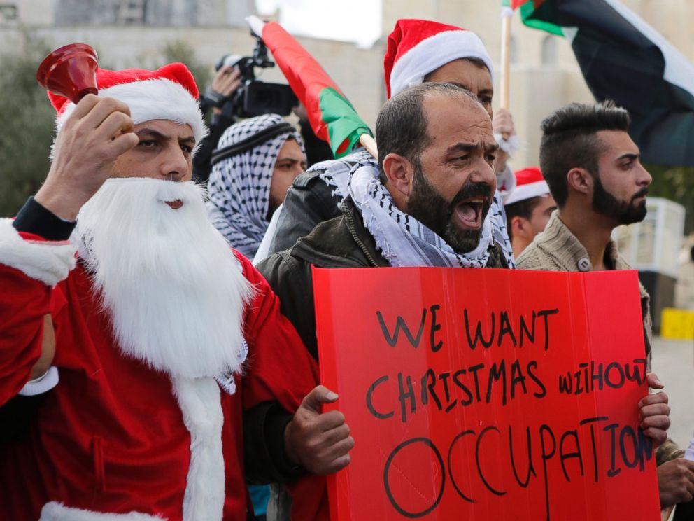 PHOTO: A Palestinian protestors demonstrate against Israeli settlements during Christmas, near a checkpoint in the West Bank city of Bethlehem, Dec. 23, 2014.