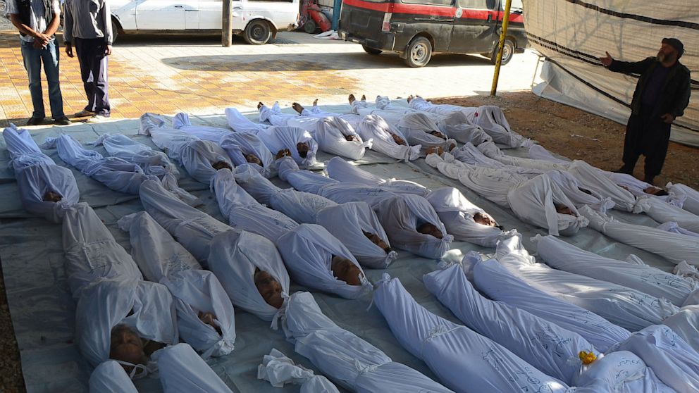PHOTO: Syrian activists inspect the bodies of people they say were killed by nerve gas in the Ghouta region, in the Duma neighborhood of Damascus on August 21, 2013.