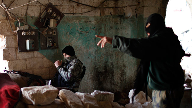 PHOTO: Fighters from Islamist Syrian rebel group Jabhat al-Nusra take their positions on the front line during a clash with Syrian forces loyal to President Bashar al Assad in Aleppo, Dec. 24, 2012.