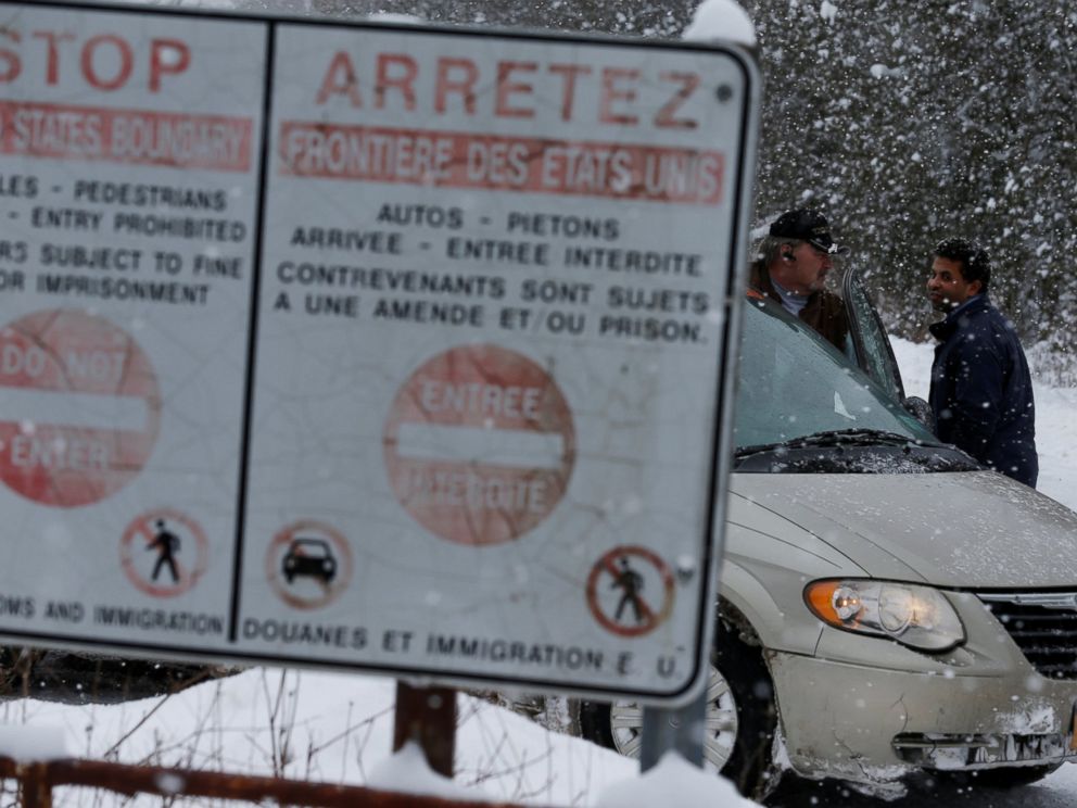 PHOTO: A man who told police he was from Sudan talks to his taxi driver after being told by Royal Canadian Mounted Police officers to go to the Lacolle border, at a U.S.-Canada border into Hemmingford, Quebec, Feb. 13, 2017.