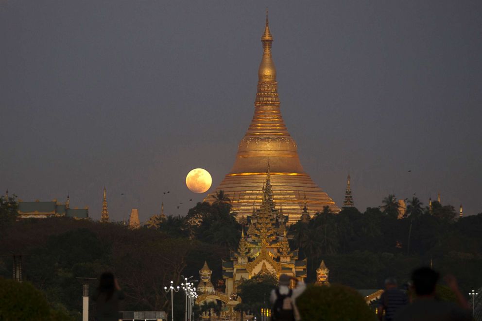 PHOTO: The moon rises behind Myanmar landmark Shwedagon pagoda on Jan.31, 2018, in Yangon, Myanmar.