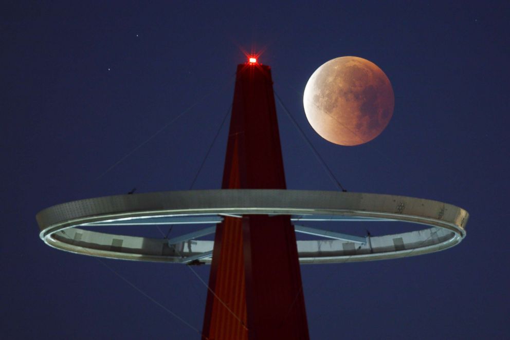 PHOTO: A super moon shines its blood red colors during a full eclipse above the Big A Sign of Angel Stadium in Anaheim, Calif., on Jan., 31, 2018.