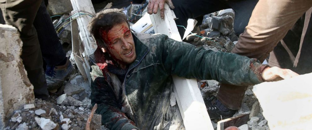PHOTO: A man stuck under debris after an airstrike in the eastern Damascus suburb of Ghouta, Syria Jan. 9, 2018.