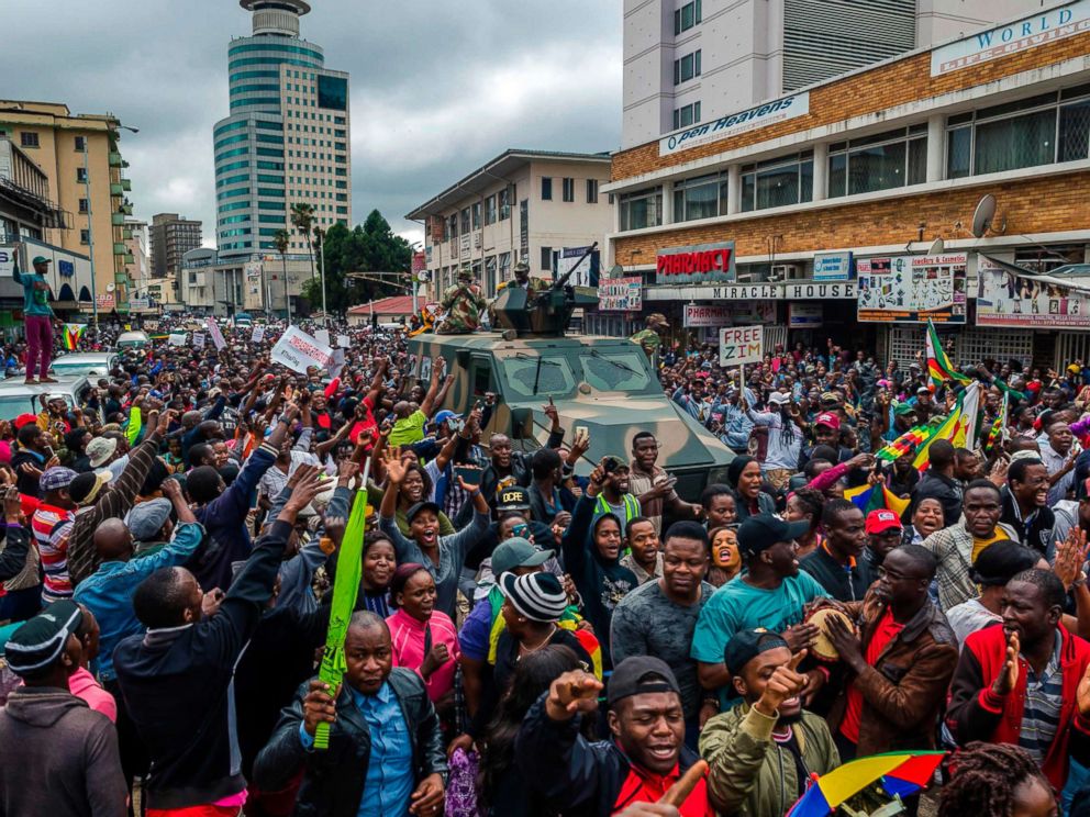 PHOTO: People cheer a passing Zimbabwe Defense Force military vehicle during a demonstration demanding the resignation of President Robert Mugabe, Nov. 18, 2017 in Harare, Zimbabwe. 