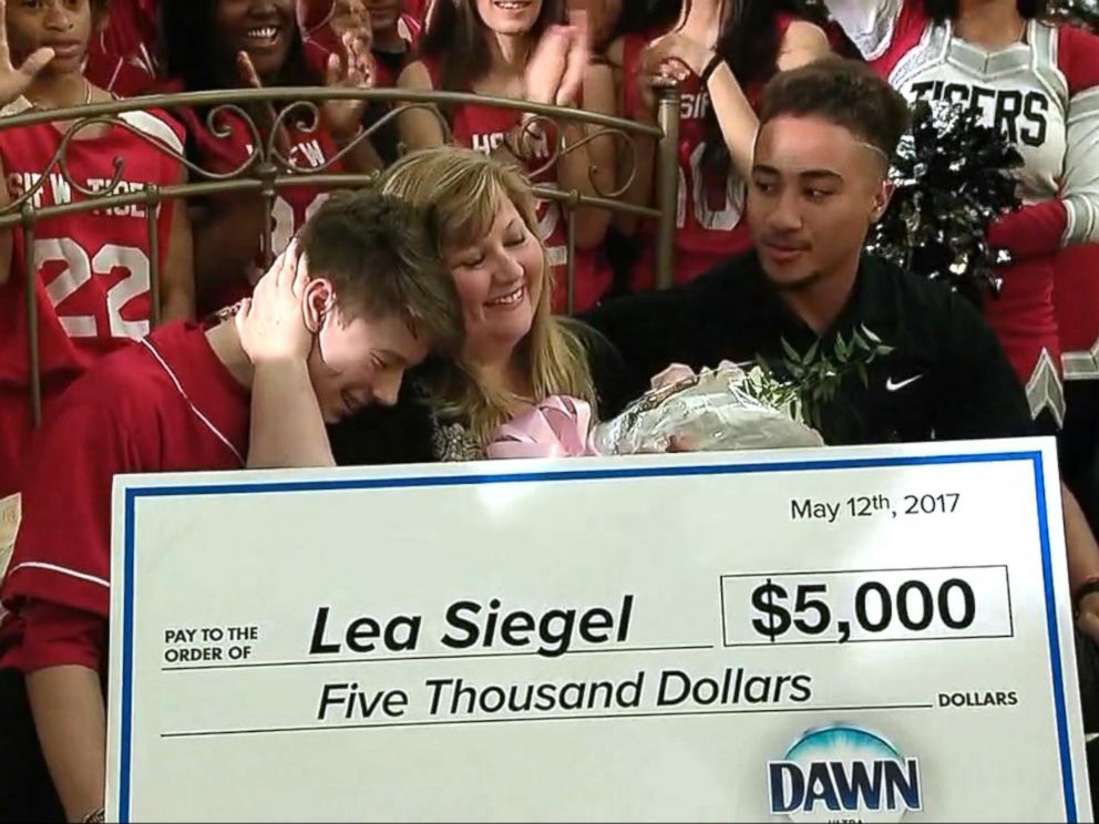 PHOTO: Emeril Lagasse named Lea Siegel, an educator from Fort Worth, Texas, the winner of his annual Breakfast in Bed search before leading her into the schools auditorium filled with students.