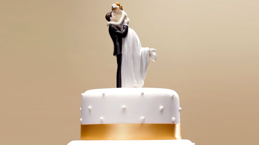 PHOTO: Bride and groom topper on a wedding cake.