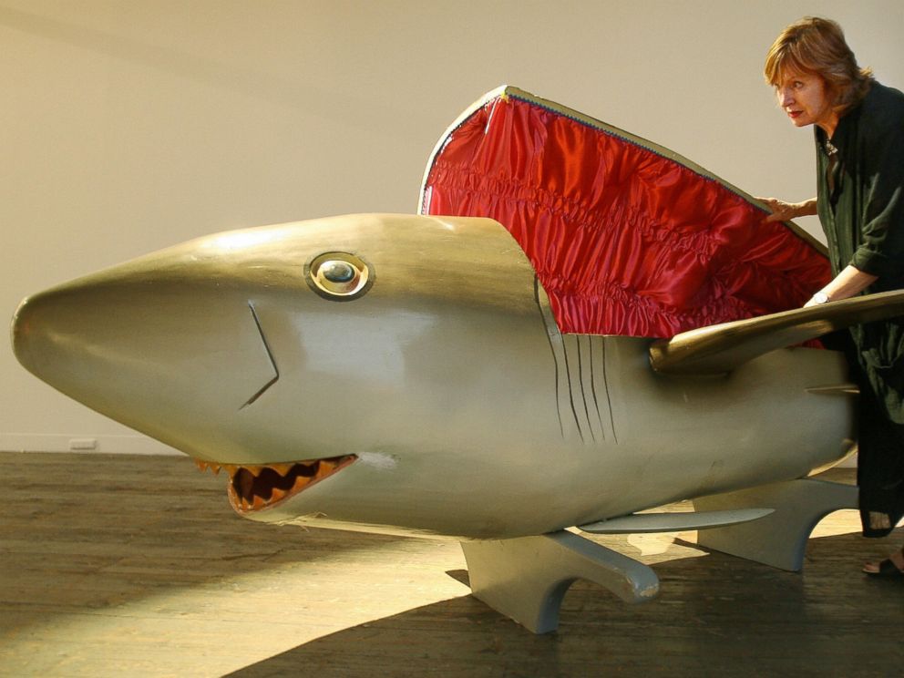 PHOTO: In this file photo, a gallery worker inspects a coffin carved in the shape of a shark by the Paa Joe Carpentry workshop in Ghana and commissioned for Festival Melbourne2006, in Melbourne, Australia on Mar. 9, 2006.