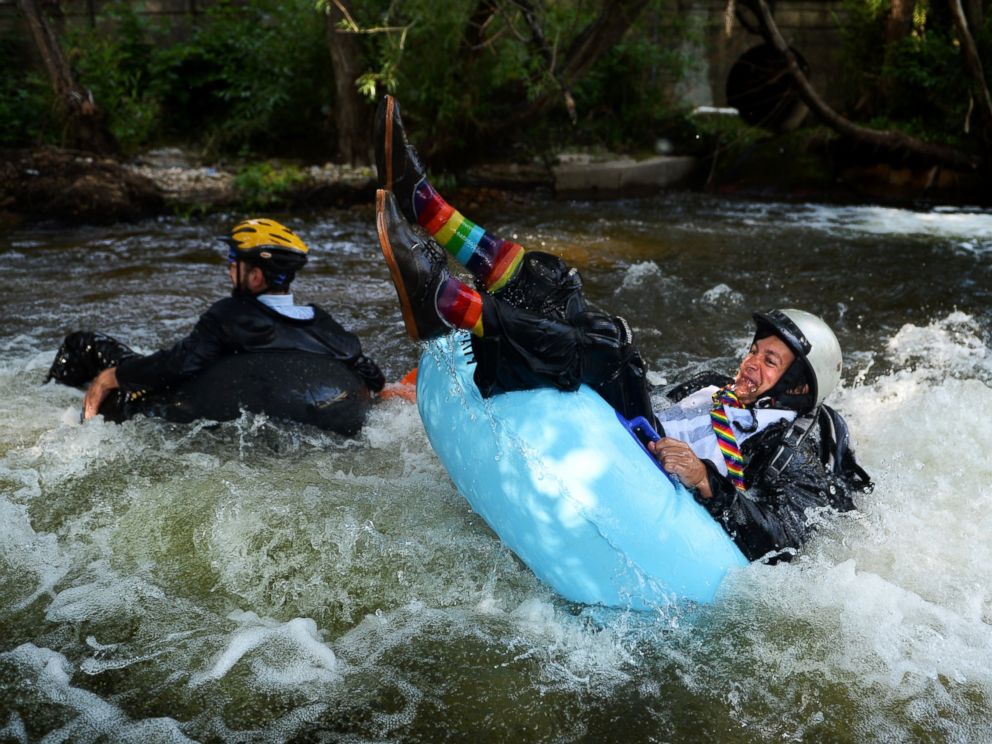 PHOTO: Jeff Kagan, left, is the founder of the seventh annual Boulders Tube to Work Day, July 15, 2014. Around 40 participants took their tubes down Boulder Creek on their way to work.