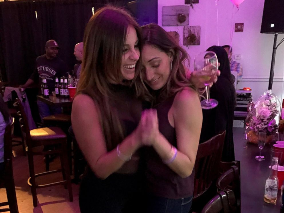 PHOTO: Andrea Sealy dancing with friend Catherine Harvey at her goodbye party inside Bop on Broad Street.