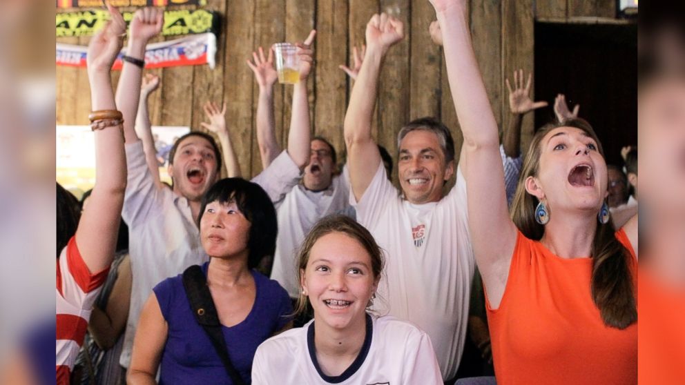 PHOTO: Fans cheer as they watch a broadcast of a United States womens soccer match at the 2012 Summer Olympics on Aug. 9, 2012, at Nevada Smiths bar in New York.