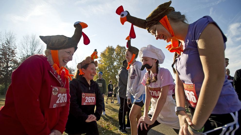 PHOTO: Dressed as turkeys and a chef, three generations of runners from the same family stretch before participating in the annual Memphis Turkey Trot race in Memphis, Tenn., Nov. 22, 2012.