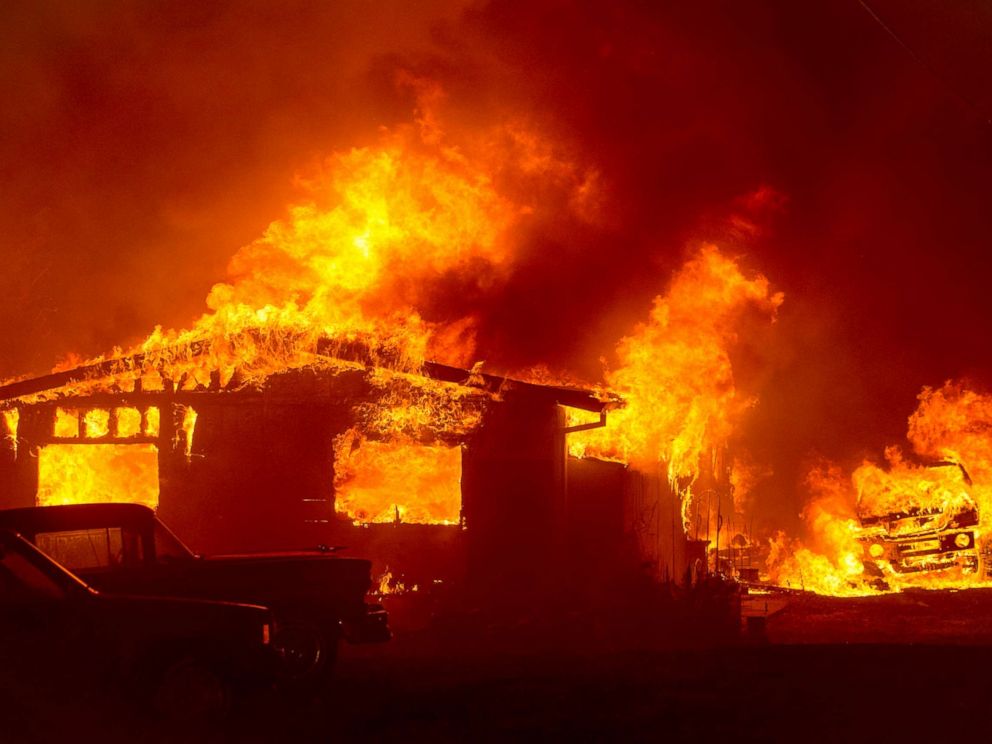 PHOTO: A car and house are engulfed in flames as the Wall Fire burns through a residential area in Oroville, California, July 8, 2017.