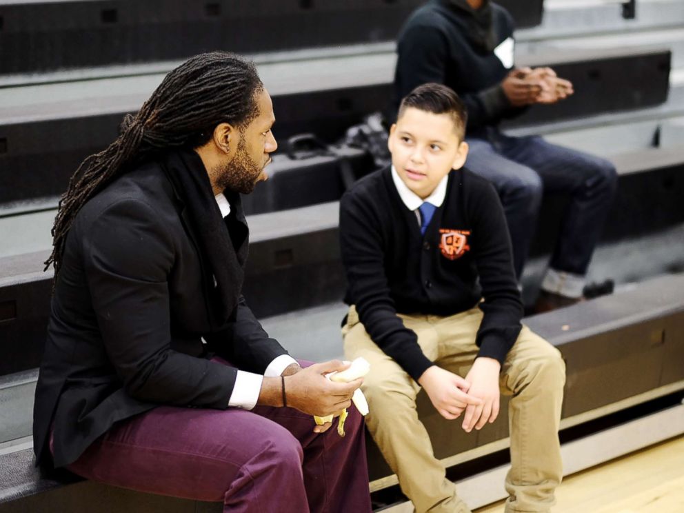 PHOTO: A mentor and a student talk during Billy Earl Dade Middle Schools Breakfast with Dads event on Dec. 14, 2017.