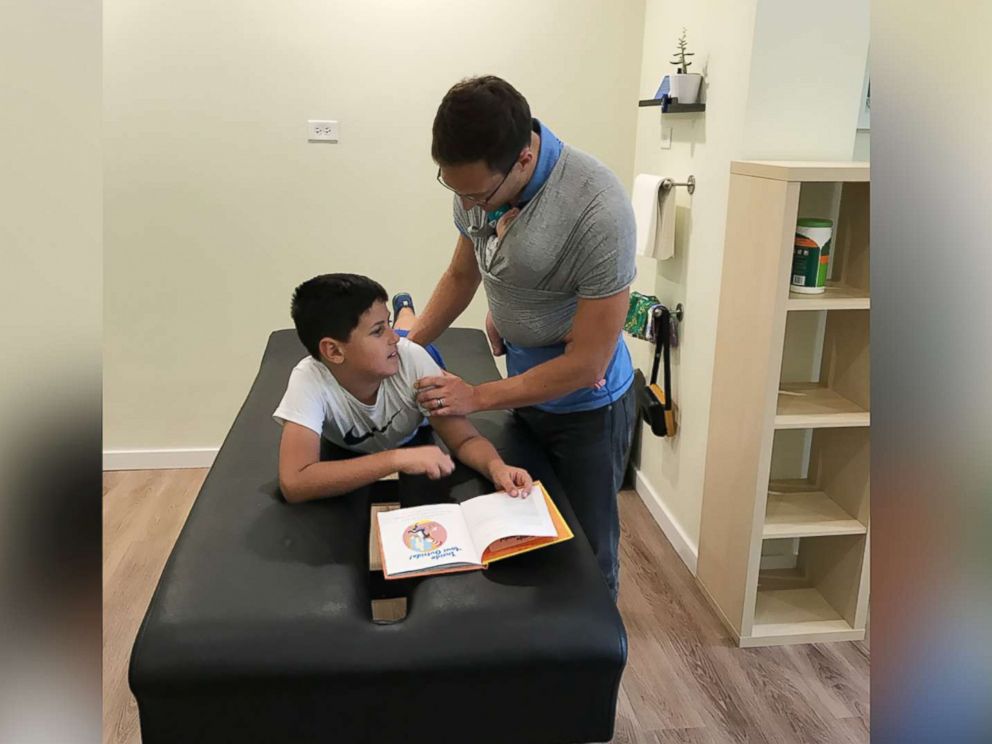 PHOTO: Yanni Rackos, 9, a patient of Roots Family Chiropractic in Chicago, Illinois, is examined by Dr. Tom Williams on July 12.