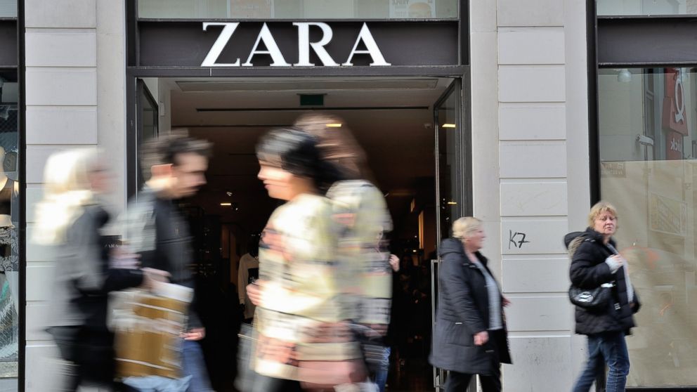PHOTO: People walk in front of the entrance of a Zara clothing store ...