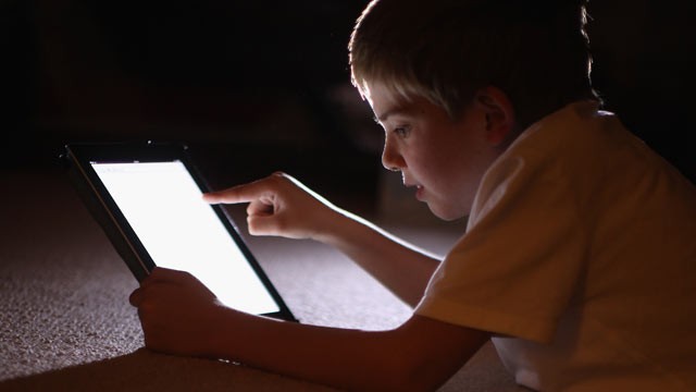 PHOTO: A ten-year-old boy uses an Apple Ipad tablet computer, Knutsford, United Kingdom, Nov. 29, 2011.