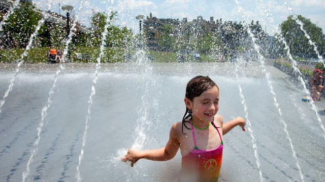 PHOTO: Sophia Tatton, 7, of Washington, cools off in the fountains at Georgetown Waterfront Park, in Washington, on Wednesday, June 20, 2012. Temperatures across the Northeast are expected to approach triple digits.