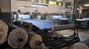 PHOTO: This picture taken on May 14, 2010, shows Pakistani employees work at a textile factory in Karachi.