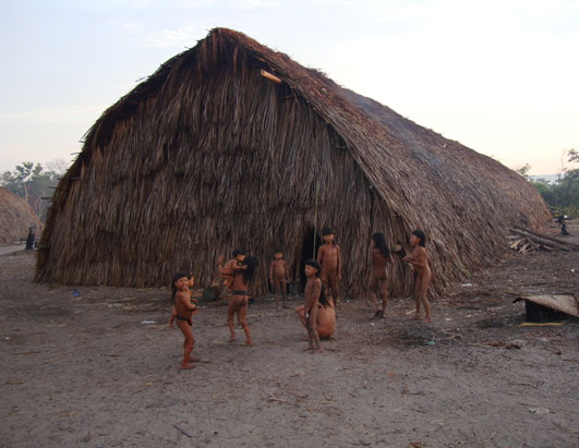 Children outside one of the communal huts, home to several families.