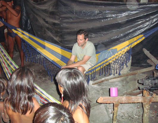 ABC News' Harris in the hut, sitting on one of the hammocks where we slept for three nights.