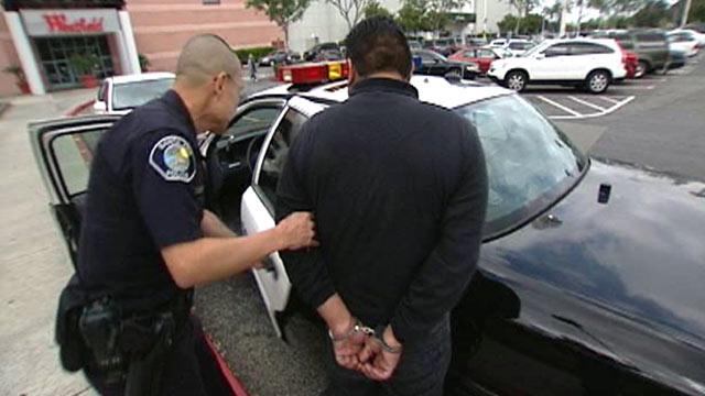 PHOTO: A California police officer arrests a man in connection to a bust of counterfeit goods.