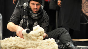 PHOTO Emerging designer, Jonathan David Baker makes a last minute alteration to a knit shrug. He found inspiration for the piece in Japanese underground culture and geisha houses.