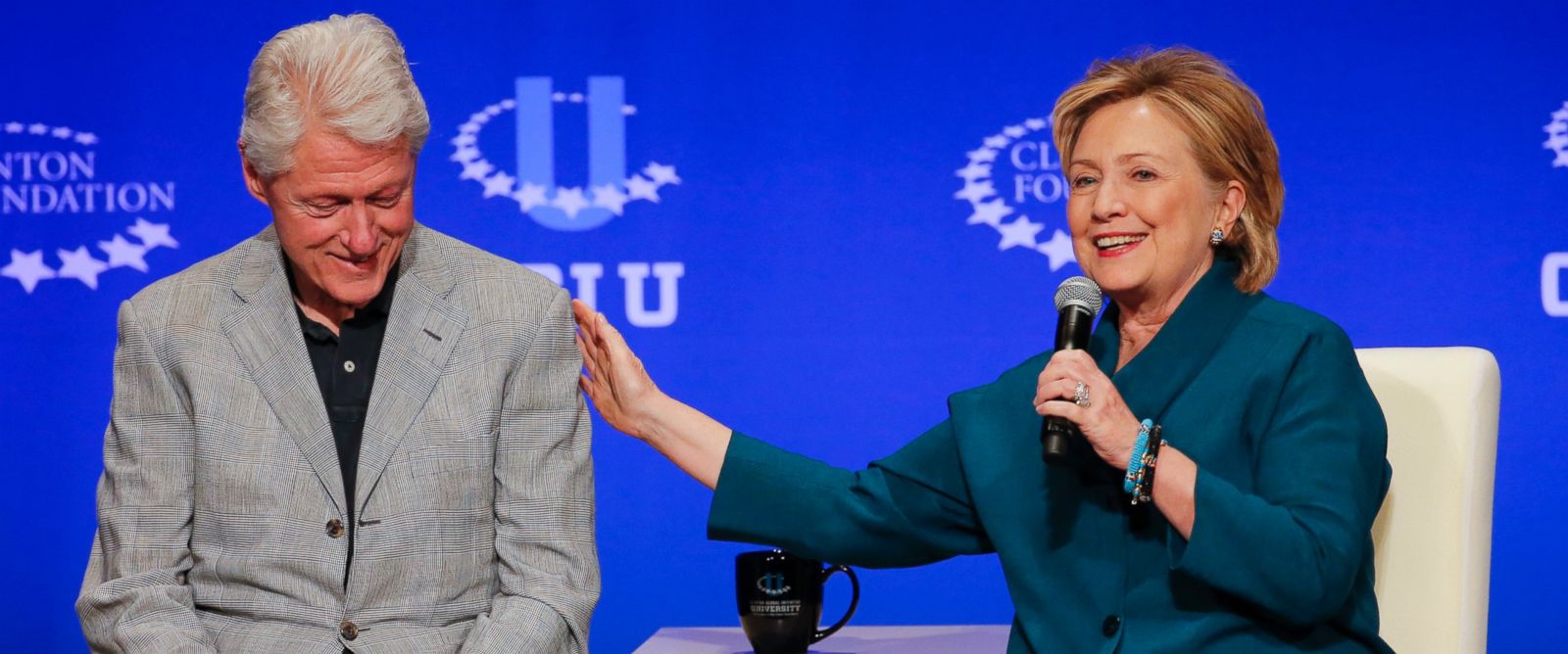 PHOTO: Bill Clinton, left, listens as Hillary Rodham Clinton speaks during a student conference for the Clinton Global Initiative University at Arizona State University in Tempe, Ariz. in this March 22, 2014 file photo.