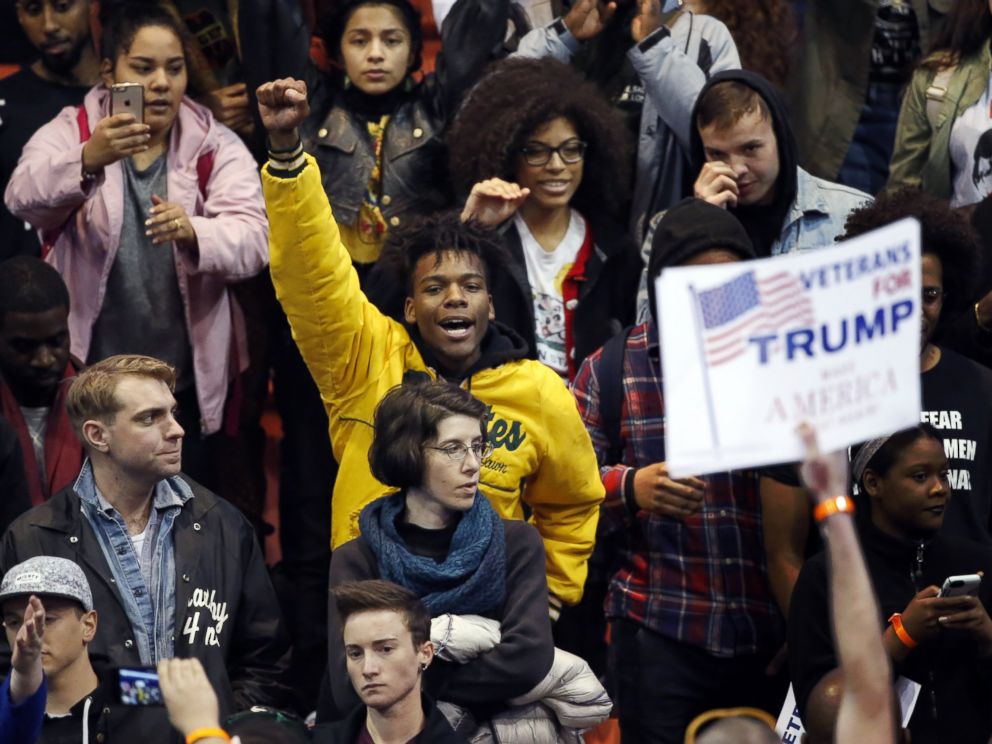 PHOTO: A protester raises his fist to supporters of Republican presidential candidate Donald Trump before a rally on the campus of the University of Illinois-Chicago, March 11, 2016, in Chicago.