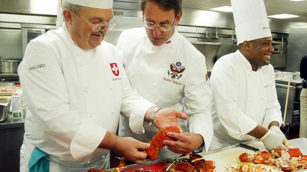 PHOTO: Heinrich Lauber, left, Chef in Charge of the Official Receptions of Switzerland, shows former White House Chef Walter Scheib, center, in this file photo, cooked lobsters, at the Willard InterContinental Washington, July 26, 2004. 