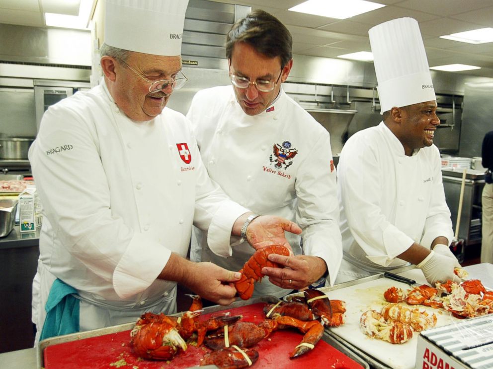 PHOTO: Heinrich Lauber, left, Chef in Charge of the Official Receptions of Switzerland, shows former White House Chef Walter Scheib, center, in this file photo, cooked lobsters, at the Willard InterContinental Washington, July 26, 2004.