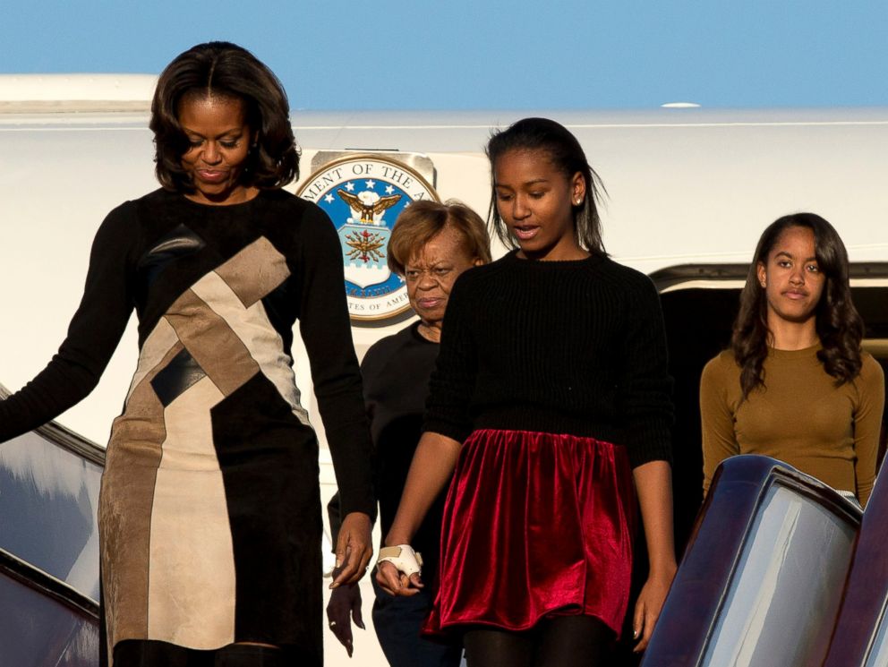PHOTO: U.S. First Lady Michelle Obama, front left, her daughters Sasha, front right, Malia, right in the back, and Michelle Obamas mother Marian Robinson, left in the back, arrive at Capital International Airport in Beijing, March 20, 2014.