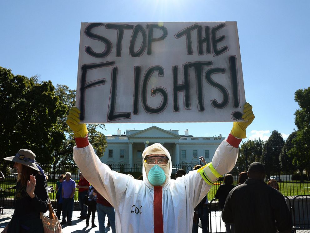 PHOTO: A protester stands outside the White House asking United States President Barack Obama to ban flights in effort to stop Ebola, Oct. 17, 2014, in Washington.