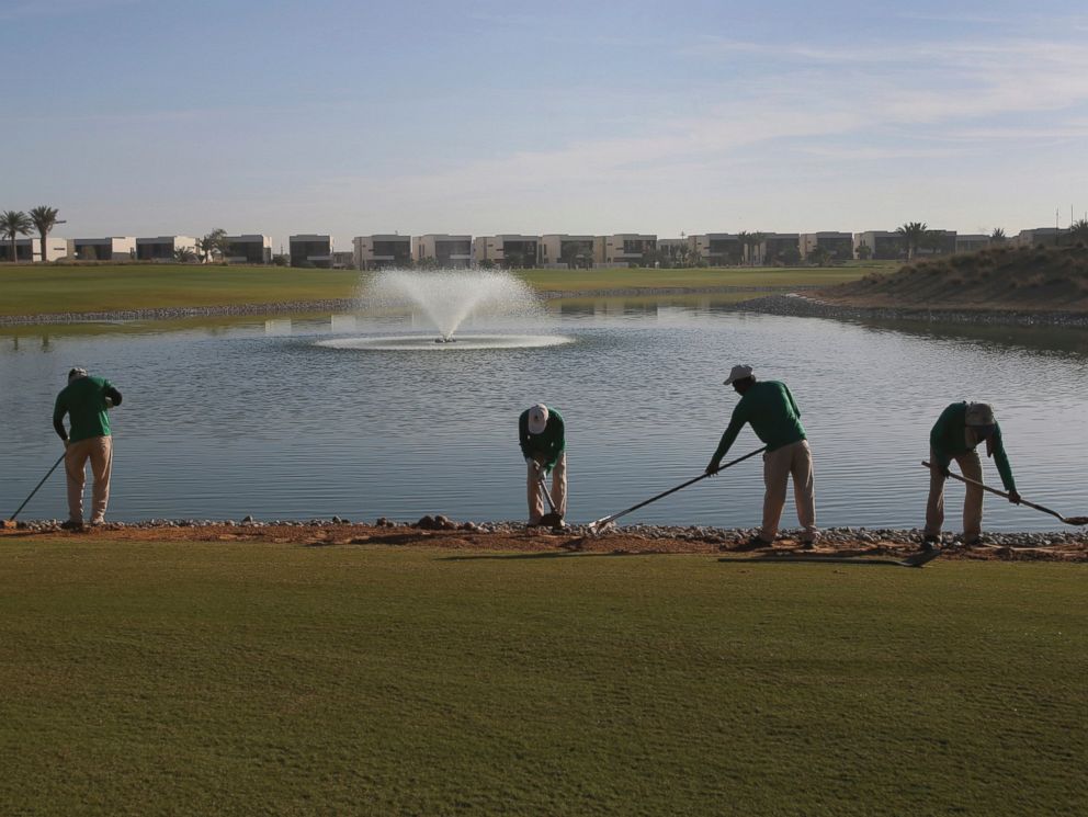 PHOTO: Gardeners put the final touches on greens at the Trump International Golf Club, in Dubai, United Arab Emirates, Dec. 20, 2016.