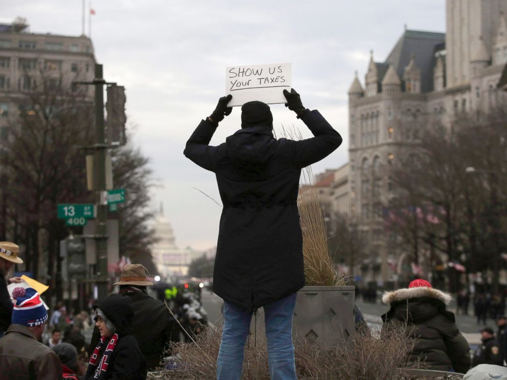 PHOTO: A person holds up a sign before the Presidential Inauguration of Donald Trump at Freedom Plaza, on Jan. 20, 2017, in Washington.