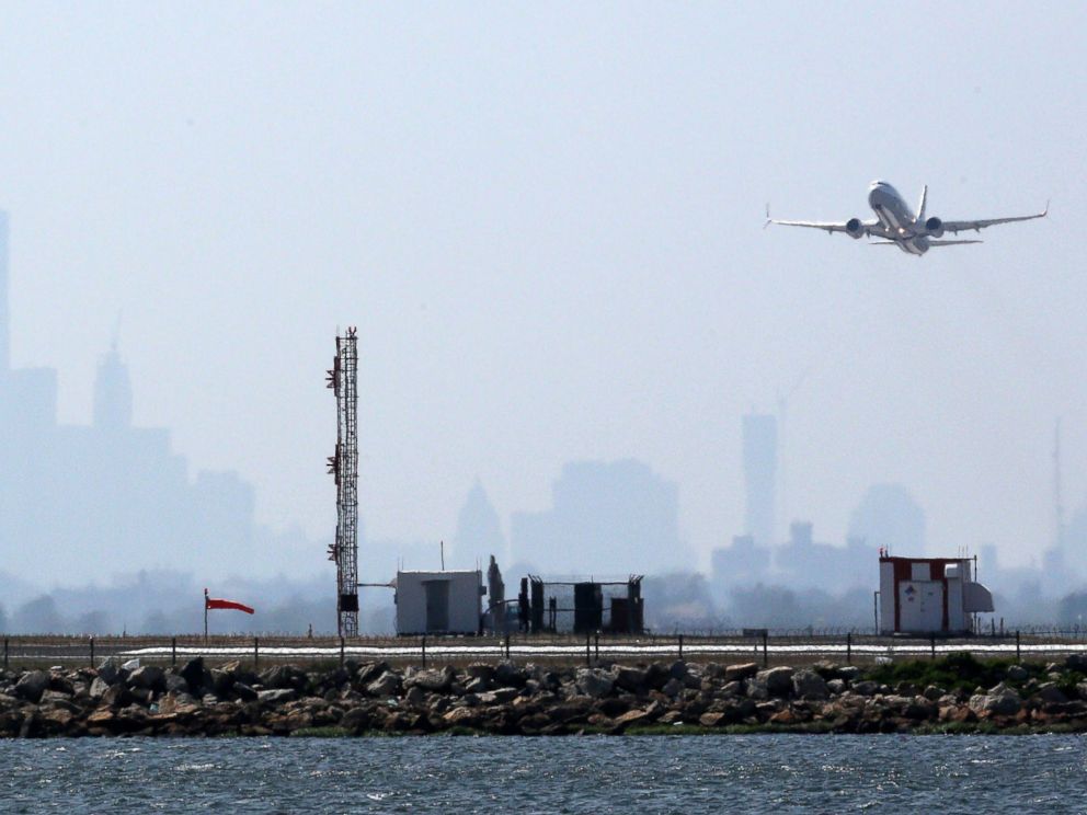 PHOTO: An aircraft takes off from New Yorks John F. Kennedy Airport against a hazy backdrop of the New York skyline, May 25, 2015.