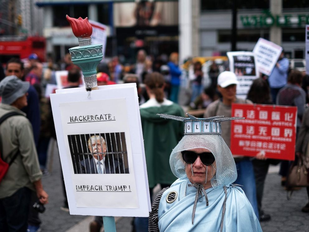PHOTO: A protester displays a placard against President Donald Trump during a demonstration to mark May Day in New York, May 1, 2017.