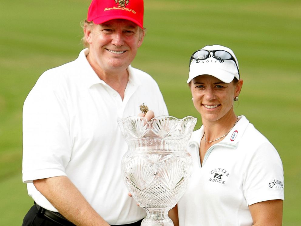 PHOTO: Annika Sorenstam of Sweden poses with Donald Trump and the trophy on the 18th green at the Trump International Golf Club, Nov. 21, 2004, in West Palm Beach, Florida.