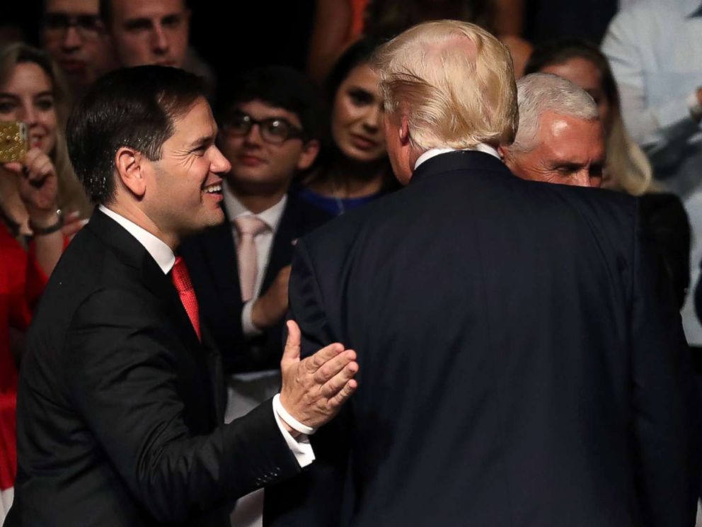 PHOTO: Sen. Marco Rubio (C) congratulates President Donald Trump after the president announced policy changes he is making toward Cuba at the Manuel Artime Theater in the Little Havana neighborhood on June 16, 201,7 in Miami.