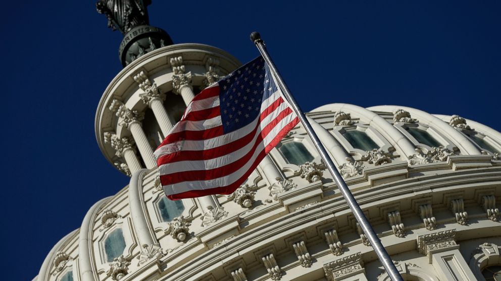 PHOTO: An American flag waves outside the United States Capitol building as Congress remains gridlocked over legislation to continue funding the federal government Sept. 29, 2013 in Washington.