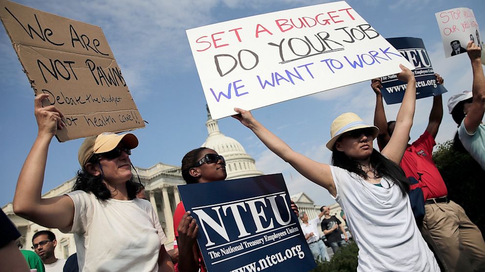 PHOTO: Furloughed federal workers protest outside the U.S. Capitol.