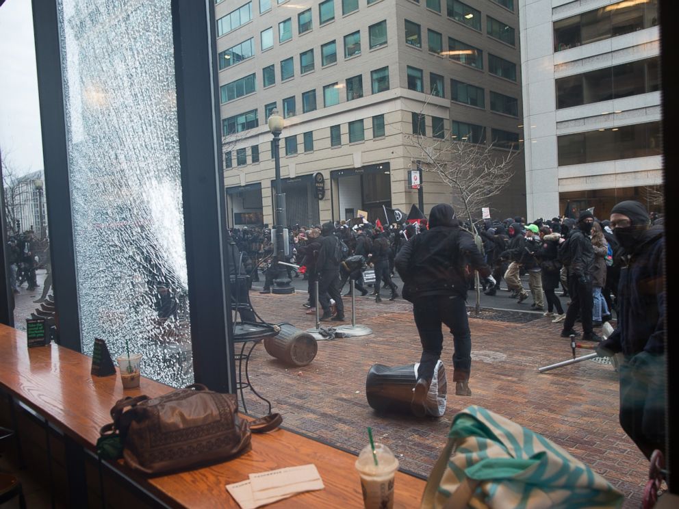 PHOTO: Anti Trump protestors hurled rocks and other debris at the Starbucks Cafe window as they ran through the streets, on Jan. 20, 2017, in Washington.