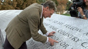 PHOTO Original stone mason John Everett Benson points out lettering he carved in 1965 on memorial wall at President John F. Kennedys tomb at Arlington National Cemetery.